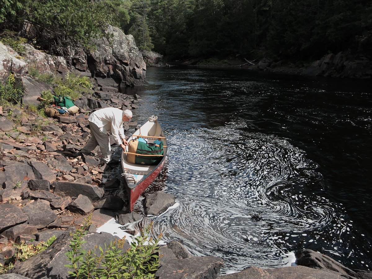 Launching canoe below the first part of Natch Rapids on the Petawawa River in Algonquin Park
