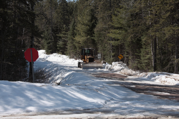 Bulldozer opening up the side road into Achray in Algonquin Park in the early spring